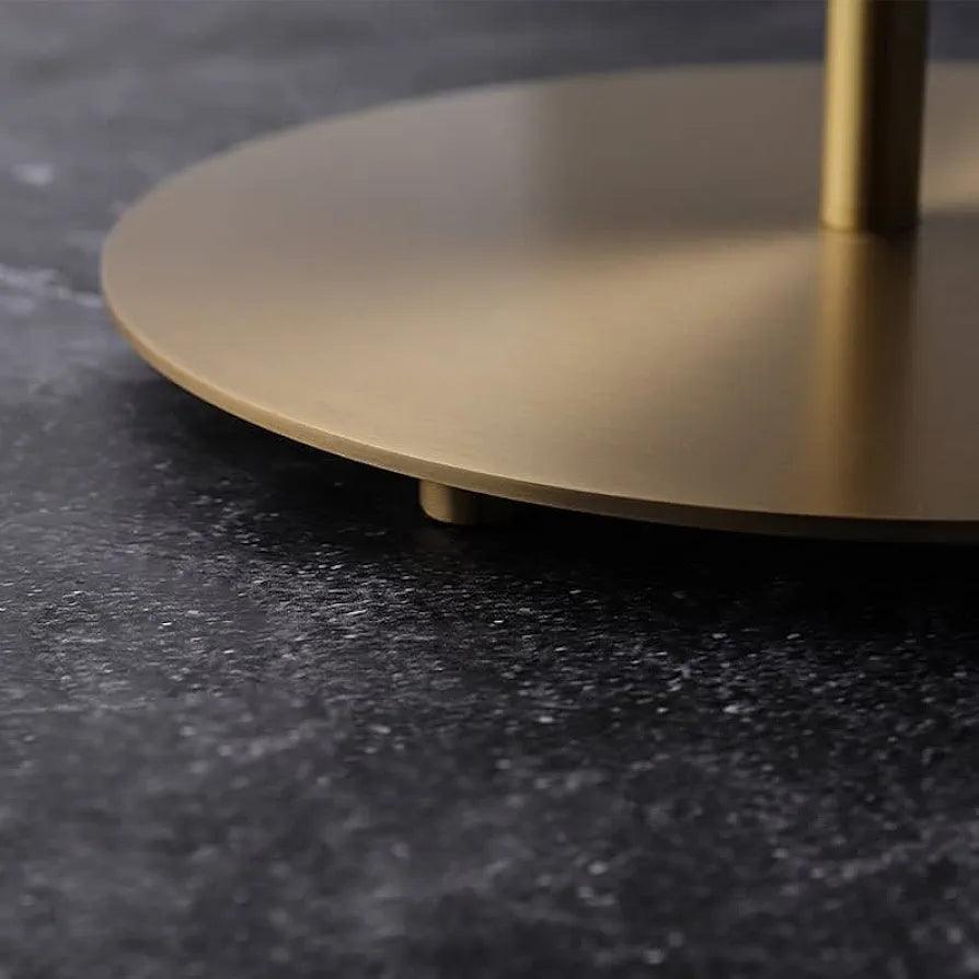 Zoomed view of lamp base – circular metal stand with gold finish
