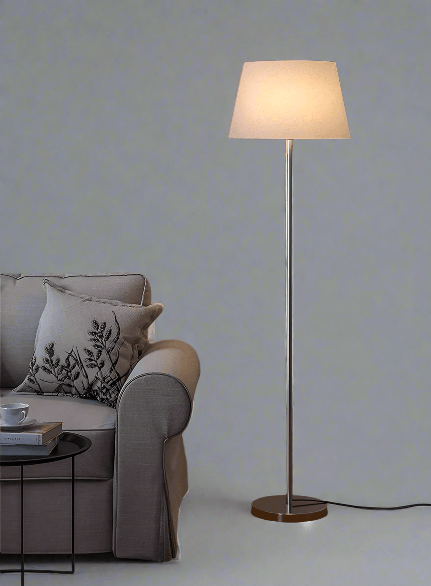 Floor lamp with fabric shade beside sofa – warm glow stainless steel body – N I CREATIONS™
