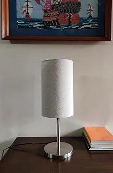 N I CREATIONS Bedside Table lamp with a modern design and fabric shade on a sleek metal base