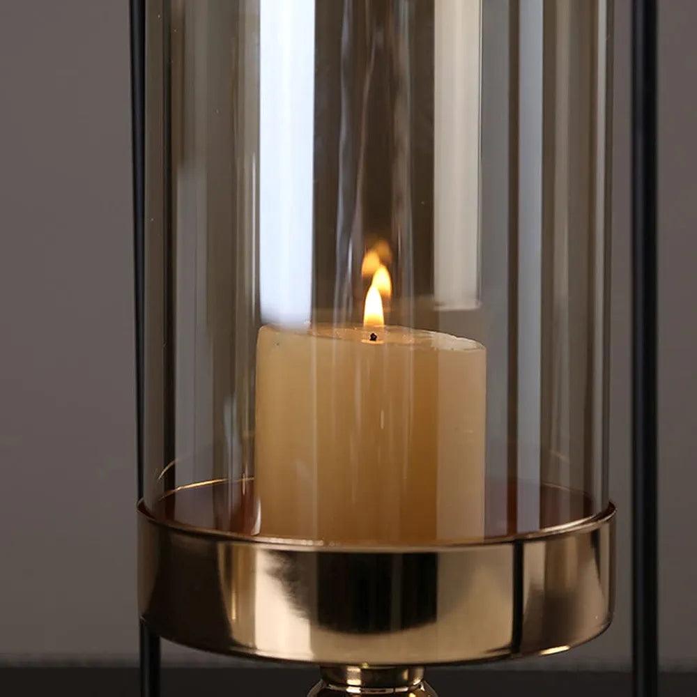 Elegant N I CREATIONS candlestick holder pillar with a glass enclosure and lit candle for home decor