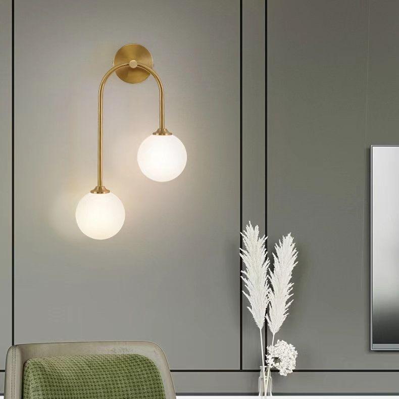 Stylish wall lamp with dual glass globes and brass accents for modern home decor