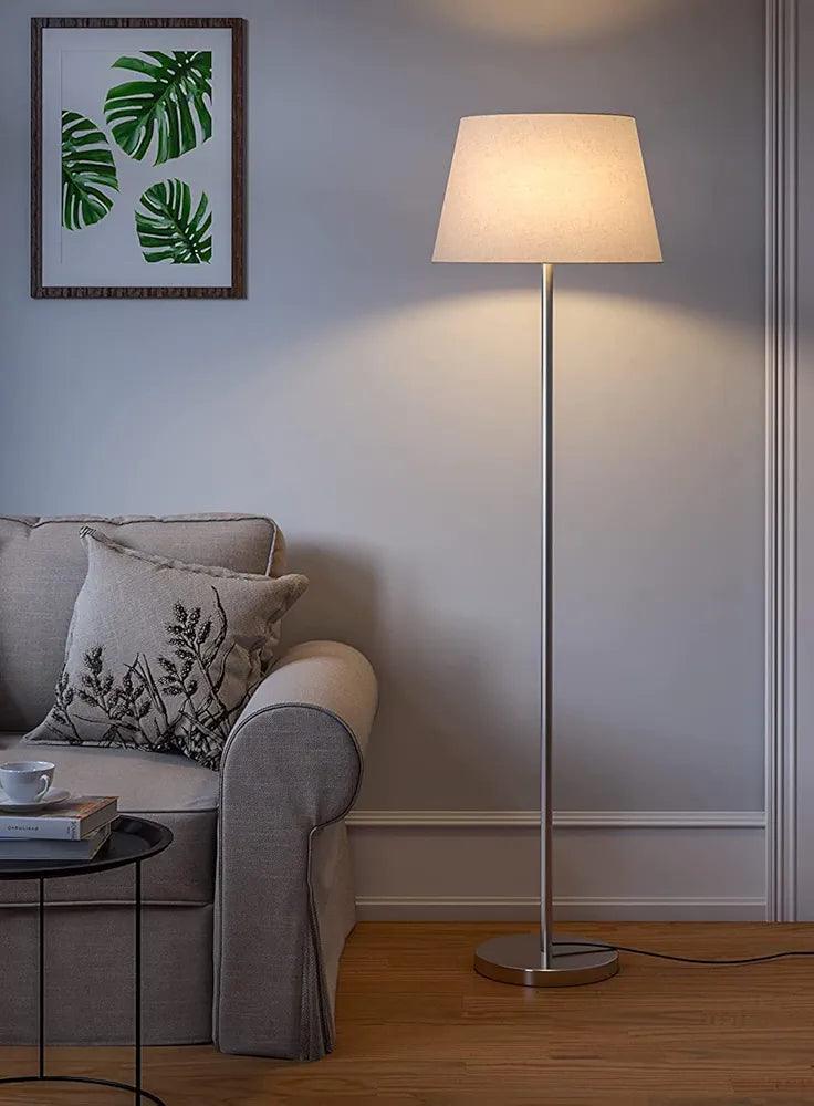 Modern N I CREATIONS floor lamp with a beige shade in a cozy living room setting