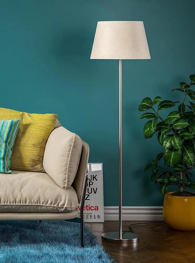 Stylish N I CREATIONS floor lamp with a cream shade beside a cozy sofa and vibrant cushions