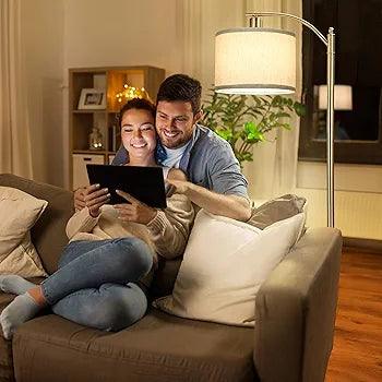 Cozy living room scene with a couple enjoying a tablet under a stylish floor lamp standing lamp