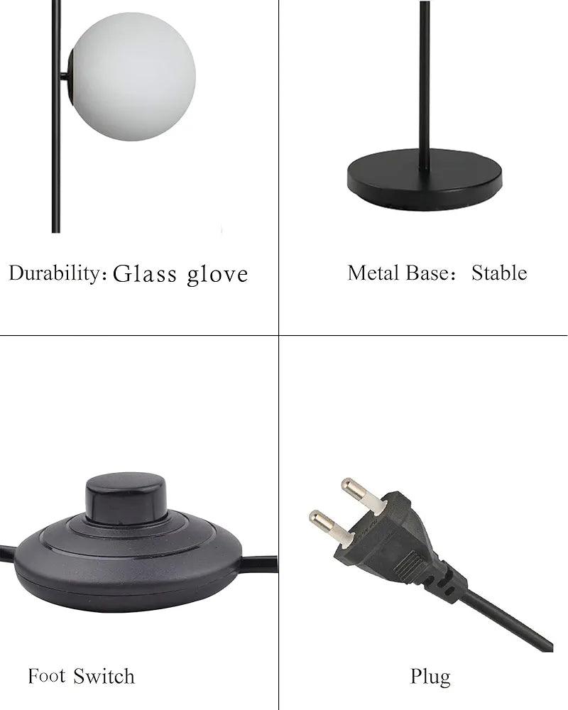N I CREATIONS floor lamp standing with glass globe shade and stable metal base featuring a foot switch.