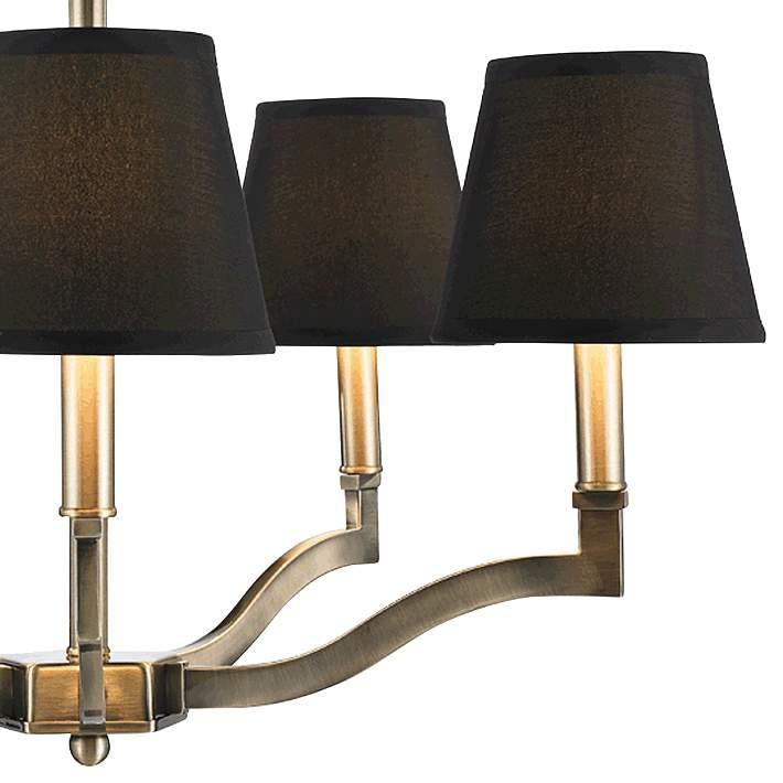 Chandelier turned on – warm ambient light glowing from shade