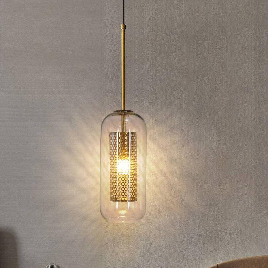 Single brass glass pendant lamp hanging against cream wall – minimalist luxury lighting