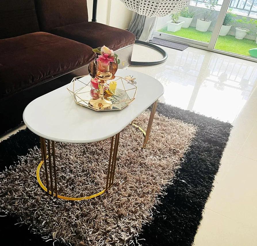 Stylish N I CREATIONS modern coffee table with gold legs in a cozy living room setting