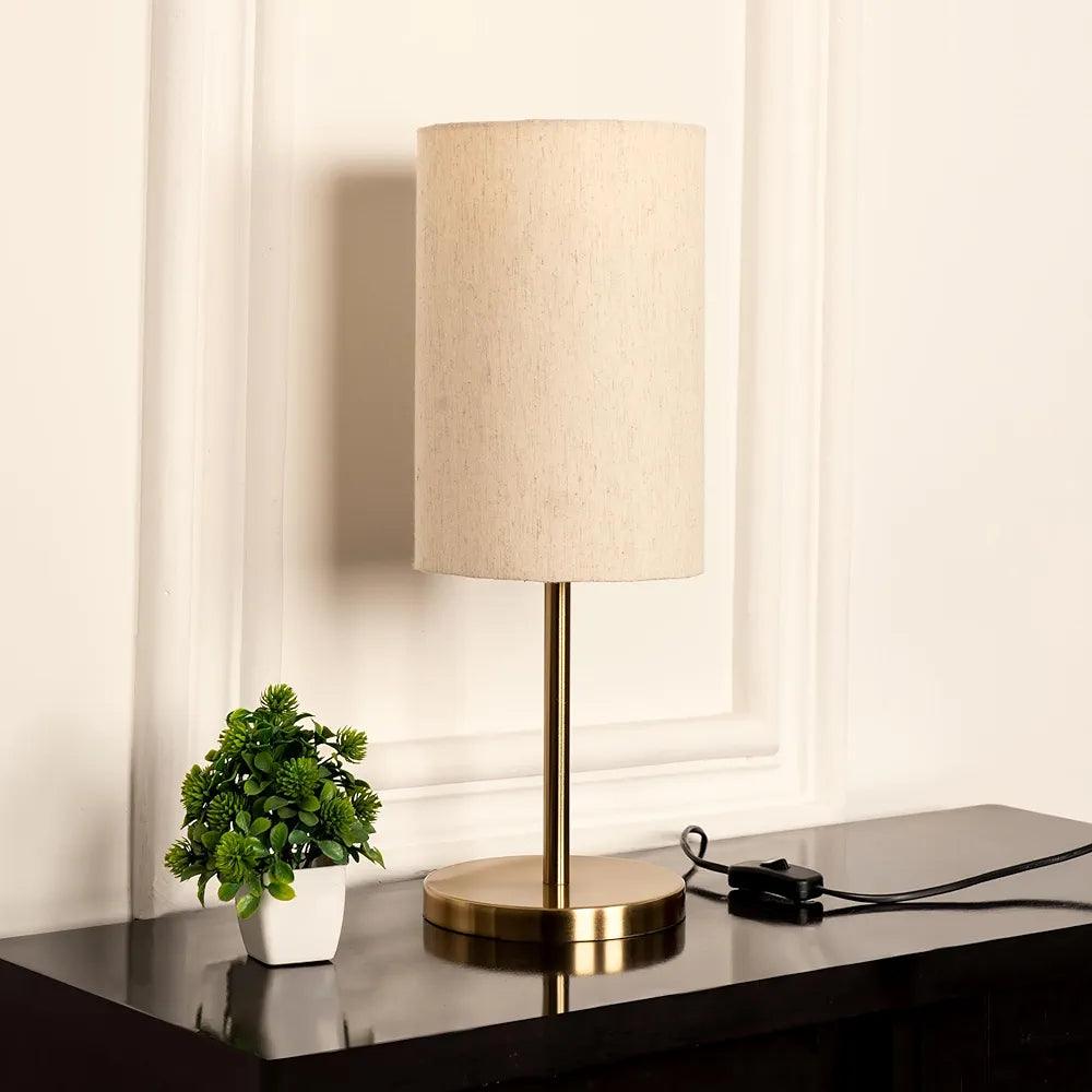 Elegant modern table lamp with a beige shade and brass base, perfect for home decoration