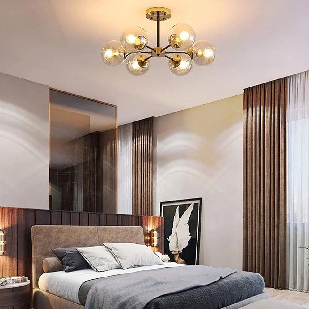 Stylish pendant lamp chandelier with spherical glass shades illuminating a modern bedroom