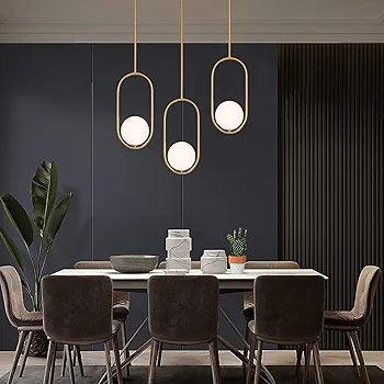 Modern N I CREATIONS pendant light featuring three globes in a stylish dining room setting