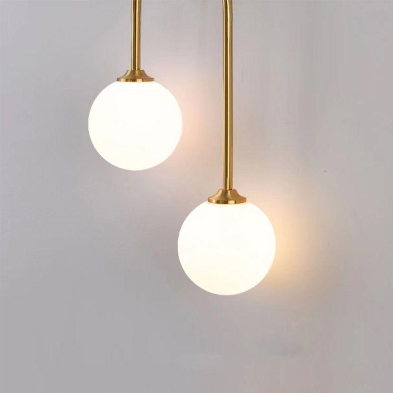 N I CREATIONS modern wall lamp featuring two elegant glass globes and a gold finish