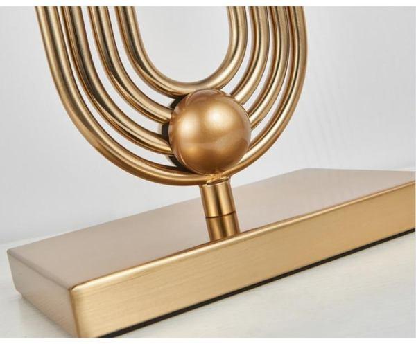 Modern N I CREATIONS table lamp with a unique geometric design and gold finish for stylish home decor