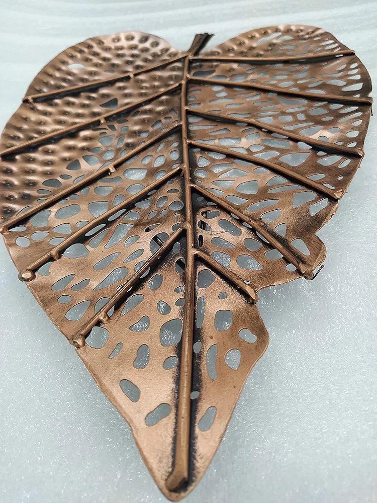 Artistic metal wall decor leaf with intricate cutouts for elegant home decoration