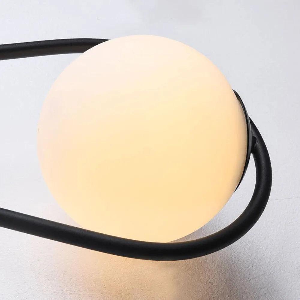 N I CREATIONS modern wall lamp with a round frosted glass shade and sleek black metal frame