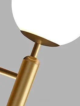Elegant N I CREATIONS wall lamp with a sleek brass finish and round glass shade for modern home decor