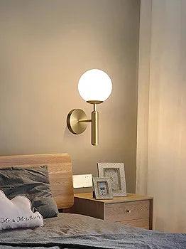 Stylish N I Creations wall lamp with a round glass shade for modern bedroom decor