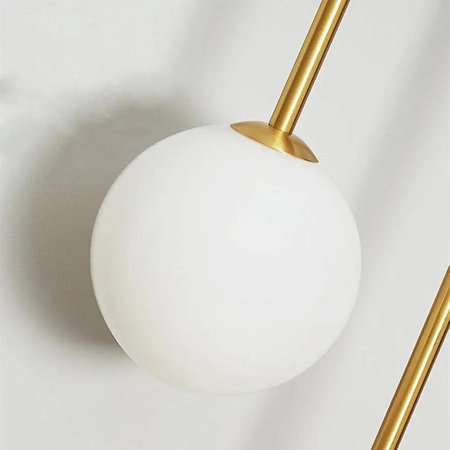 Elegant N I CREATIONS wall lamp light featuring a sleek gold finish and a round white glass shade