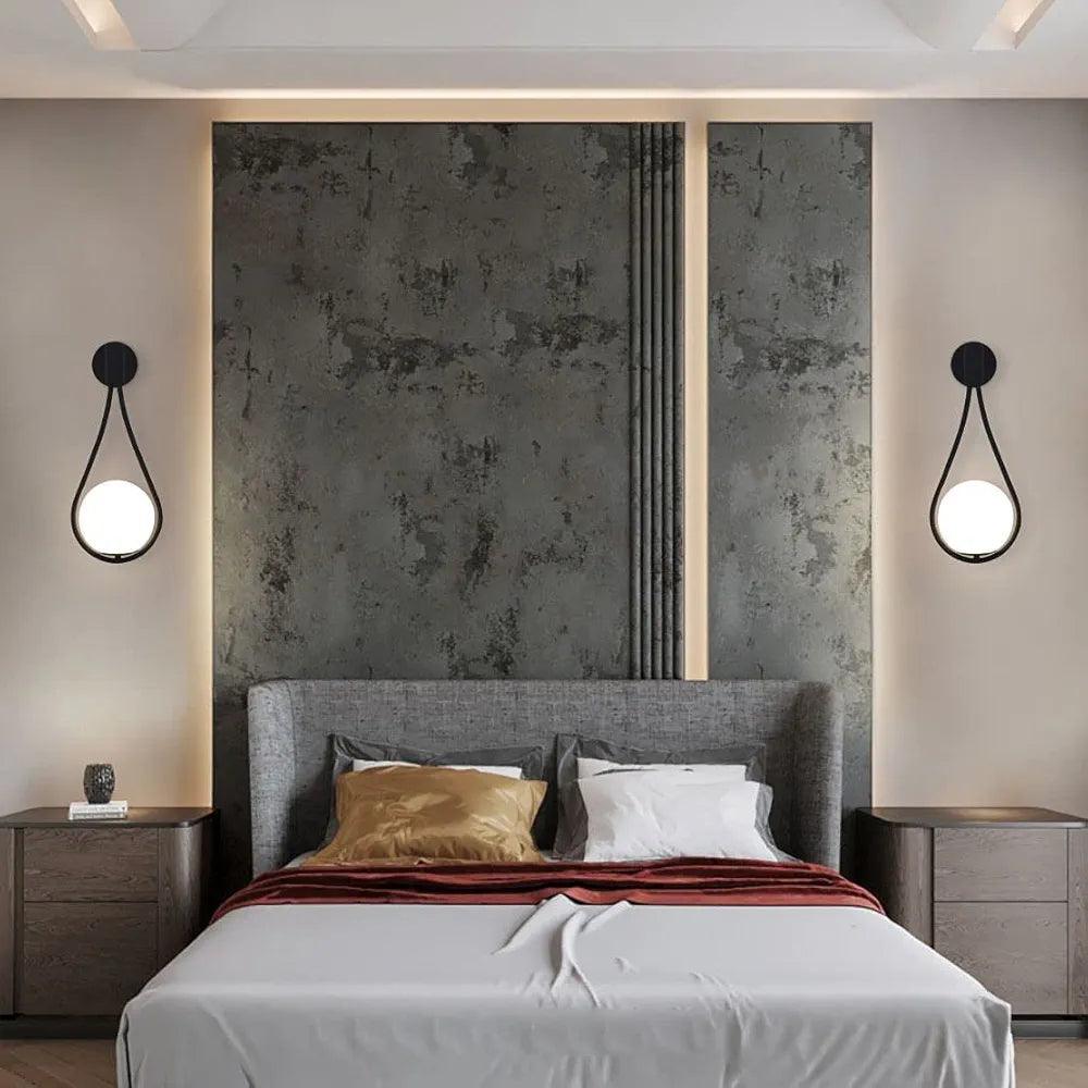 Modern wall lamp by N I CREATIONS illuminating a stylish bedroom with gray walls and a sleek bed design
