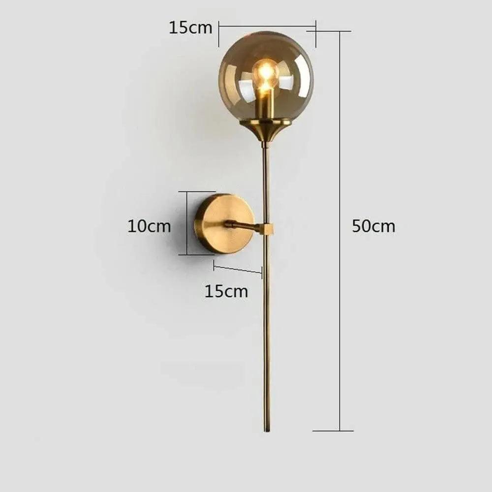 Elegant N I CREATIONS wall light with a gold finish and round glass shade for home decoration