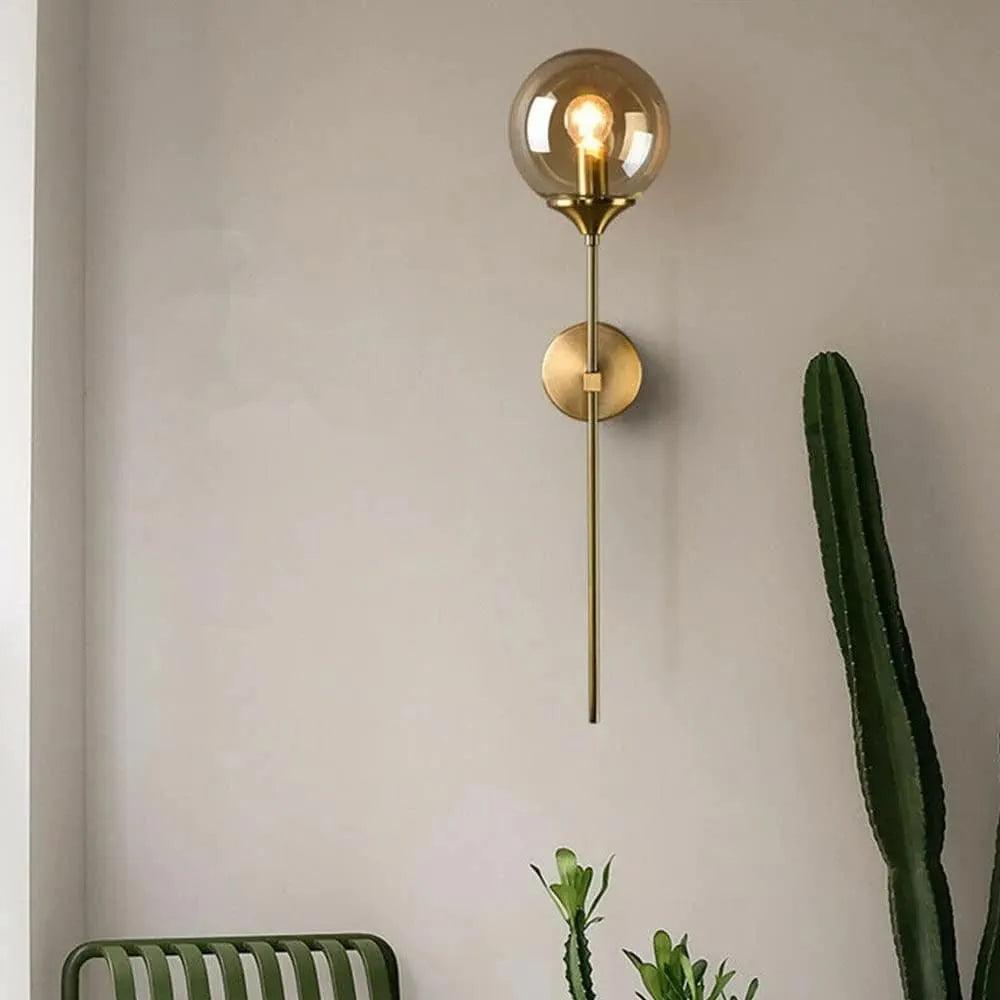 Elegant N I CREATIONS wall light with a golden finish and a globe bulb for stylish home decor