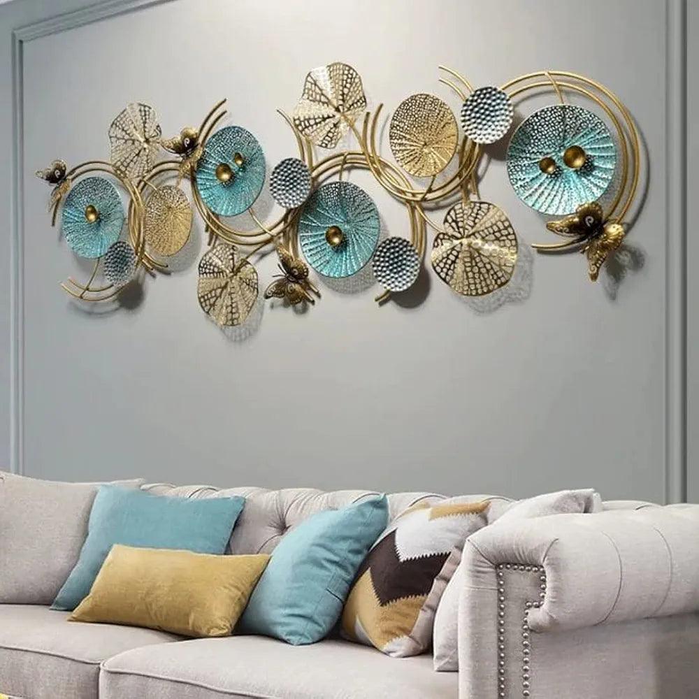 N I CREATIONS decorative wall sculpture featuring circular designs in gold and teal colors above a modern sofa
