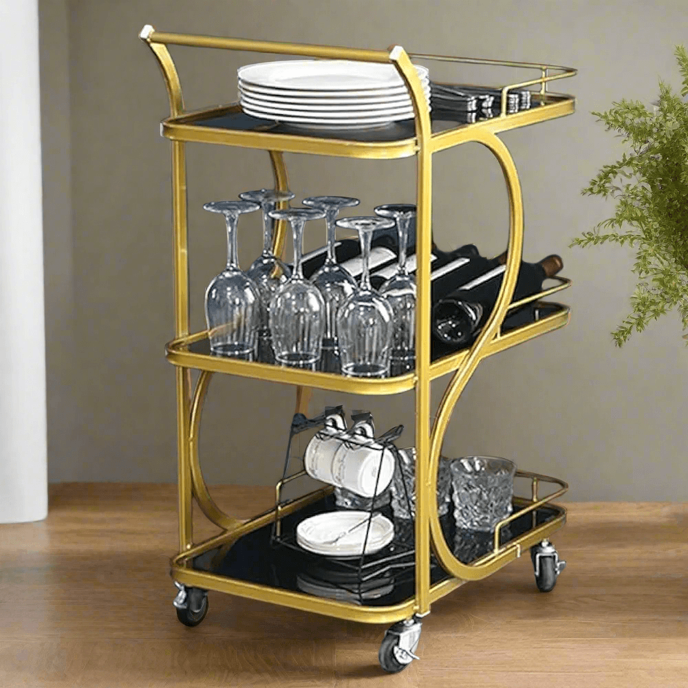 Elegant gold bar trolley with glassware and plates, perfect for serving drinks at home gatherings