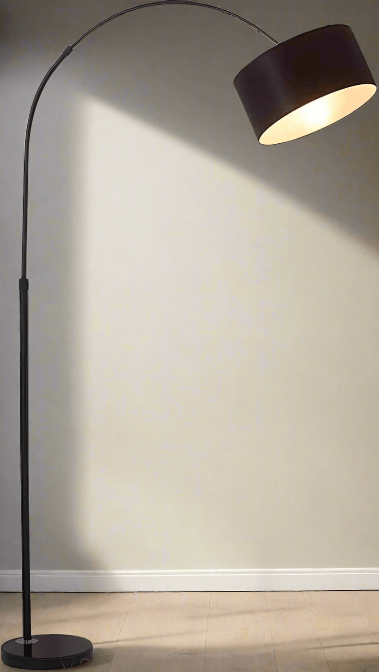 Elegant floor lamp with fabric shade and sleek curve — side view with light on.