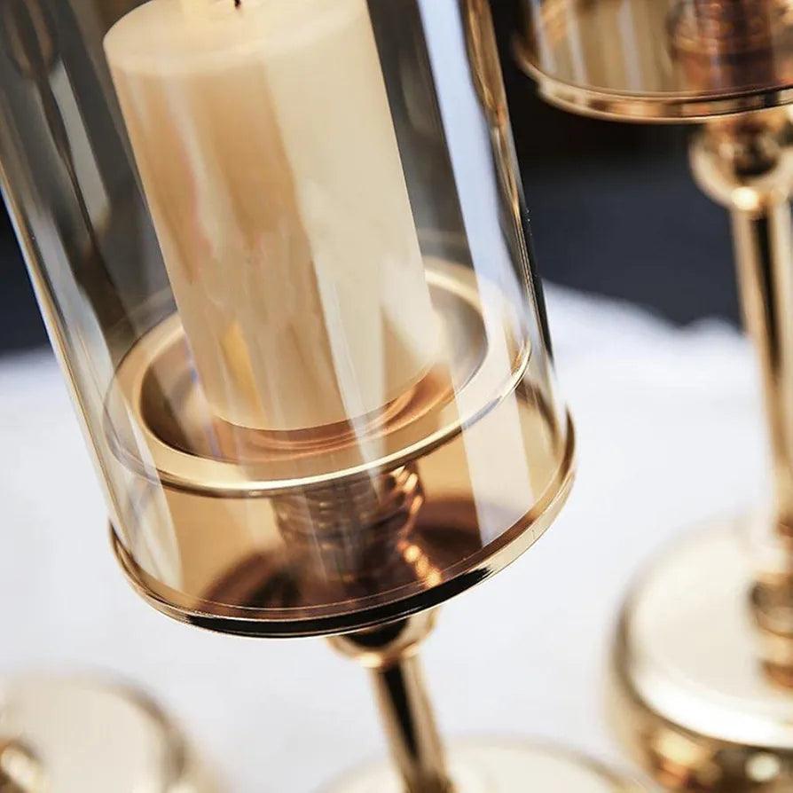 Elegant candle holders stand in gold finish with clear glass for home decoration