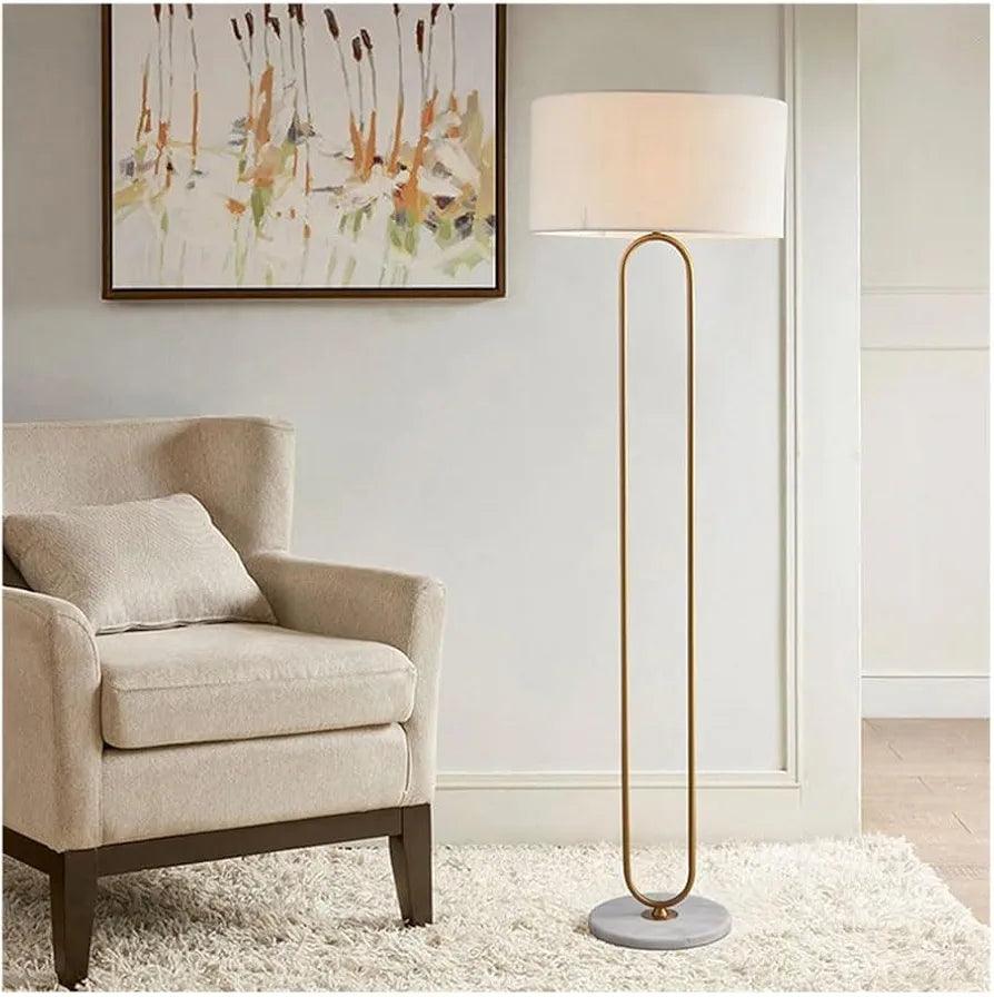 N I CREATIONS modern floor lamp standing with a white shade and gold accent in a cozy living room setting