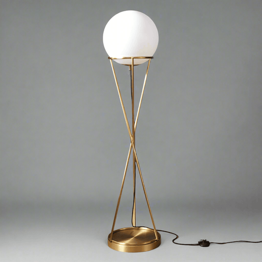Modern N I CREATIONS floor lamp standing with a sleek gold frame and a round white shade