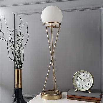 Gold-plated Sybils orb lamp placed on table, foot switch off, ideal for desk lighting