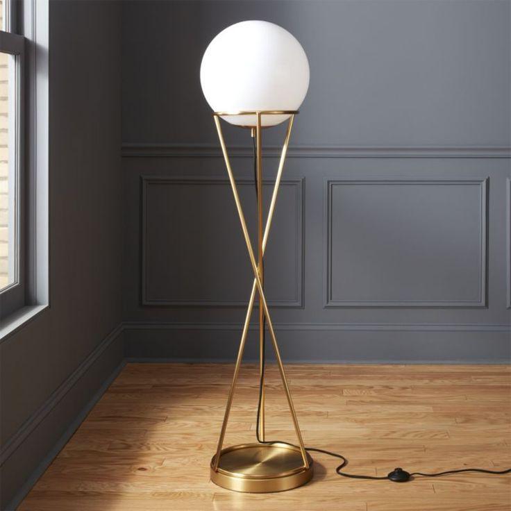 Stylish gold orb lamp in room corner with soft ambient lighting and modern furniture