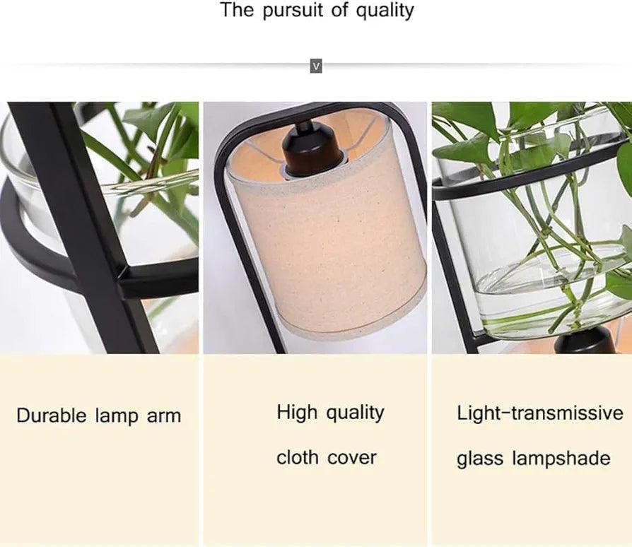Zoomed-in view showing the smooth metal finish, textured fabric shade, and glass planter detailing of the floor lamp