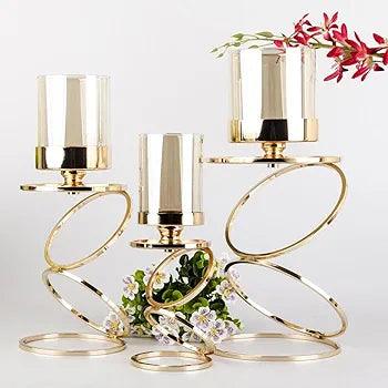 Set of elegant N I CREATIONS candle holders with a modern spiral design and glass shades