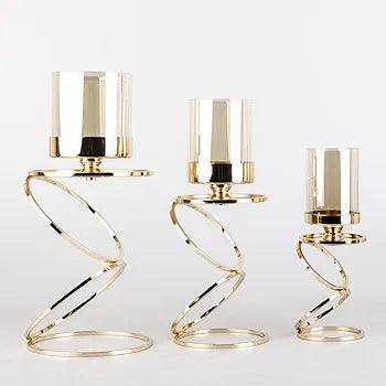 Elegant N I CREATIONS candle holders set with spiraled gold bases and glass tops for stylish decor