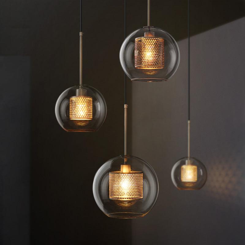 Four antique brass transparent glass chandeliers lit up against dark background – N I CREATIONS™
