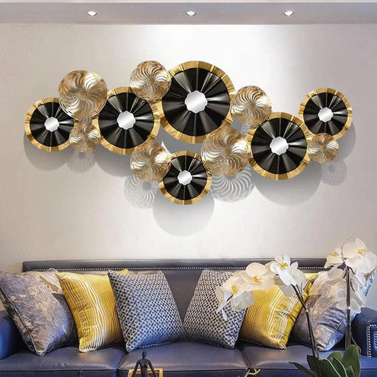Black and gold metal wall art from N I CREATIONS™ hung above a sofa on living room wall