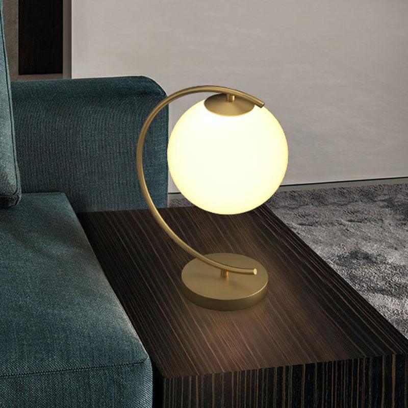 Modern N I CREATIONS night lamp featuring a round glowing bulb on a curved stand for stylish home decor