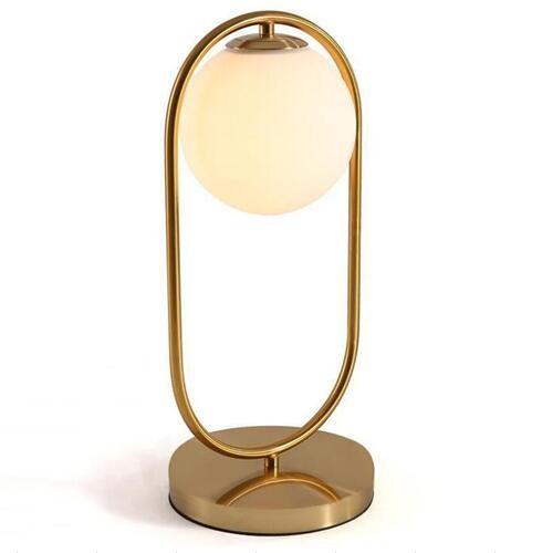 Modern gold night table lamp with a round glass shade for stylish home decor