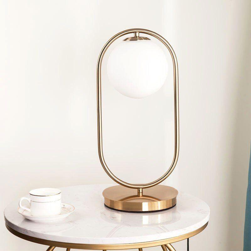 N I CREATIONS Night table lamp with a modern design and a round glass shade on a stylish base