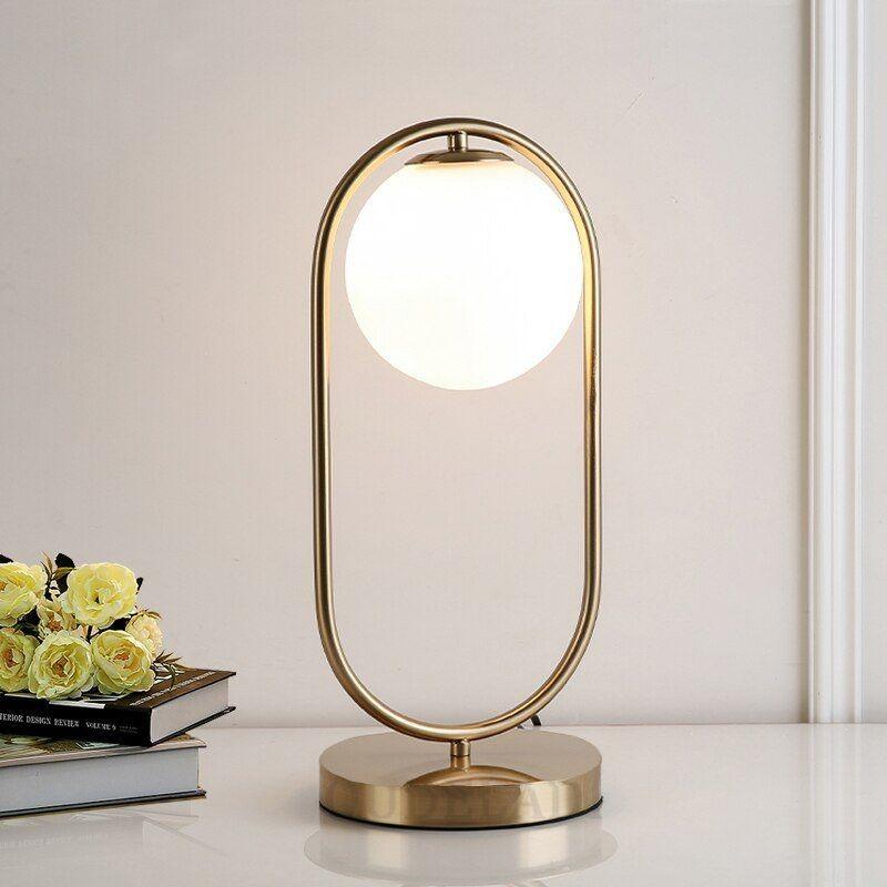 Elegant N I CREATIONS night table lamp with a gold frame and circular glass shade for modern decor