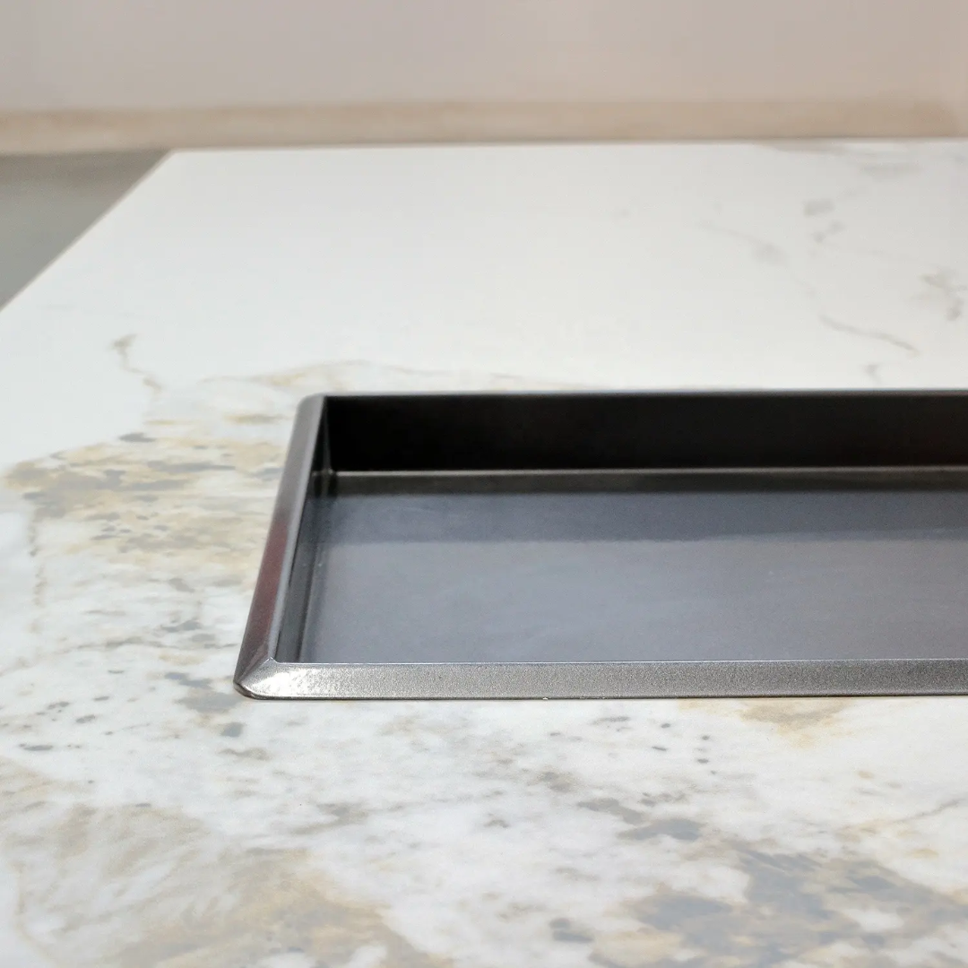 Metal baking tray on a marble countertop
