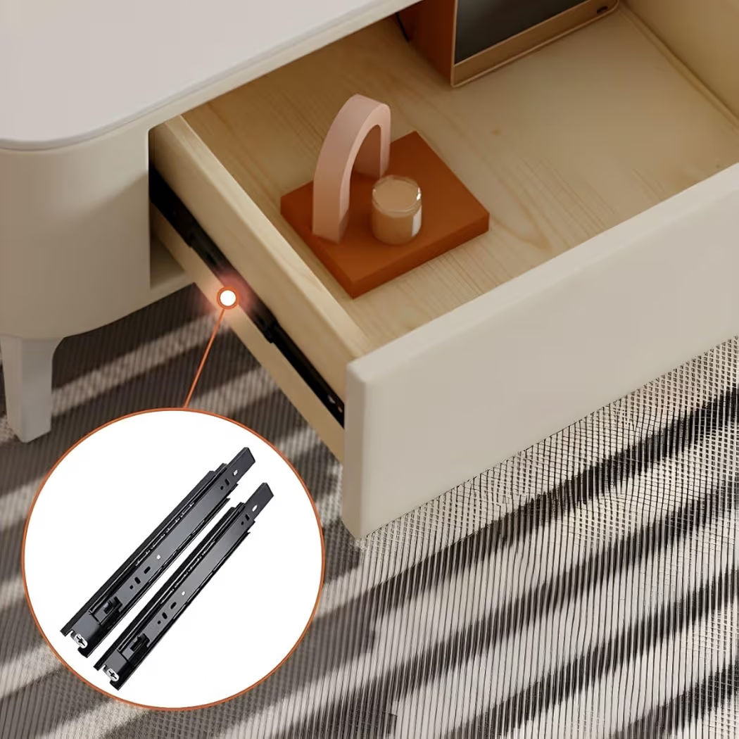 Close-up of a drawer with a small table and decorative items, inset showing two black drawer slides.
