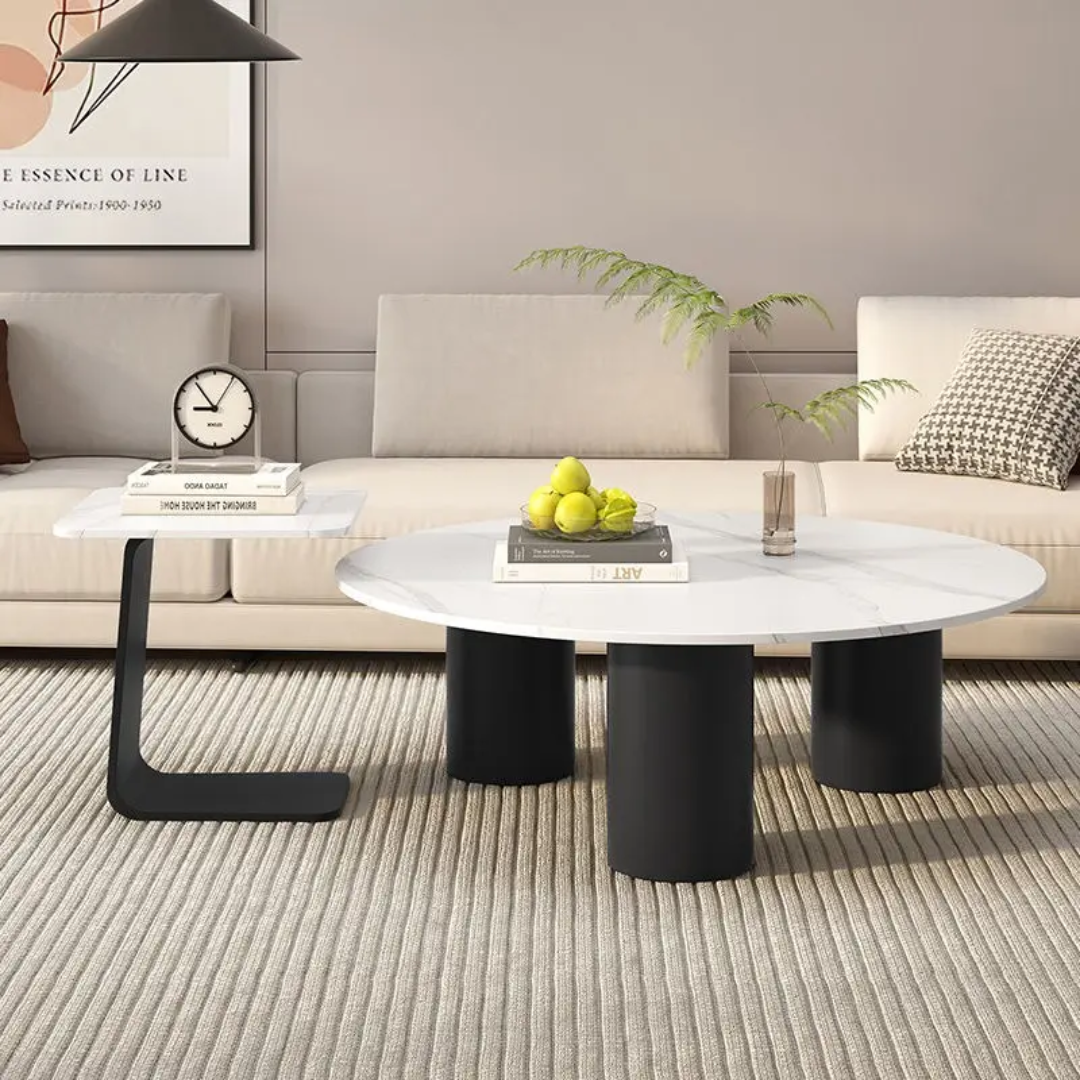 Modern living room with a white coffee table, black side table, and gray sofa.