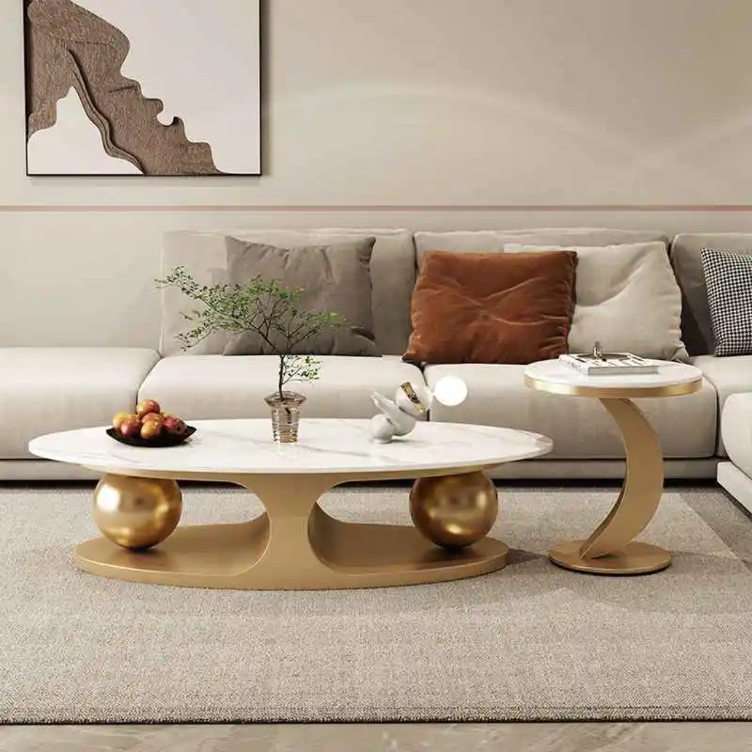 Modern living room with a white sofa, decorative pillows, and a coffee table with gold bases.