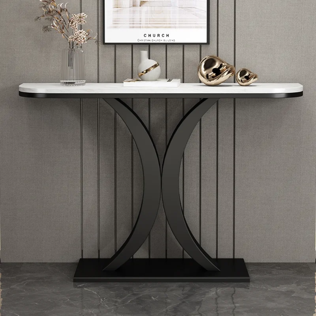 Console table with marble top and black metal base against a gray wall.