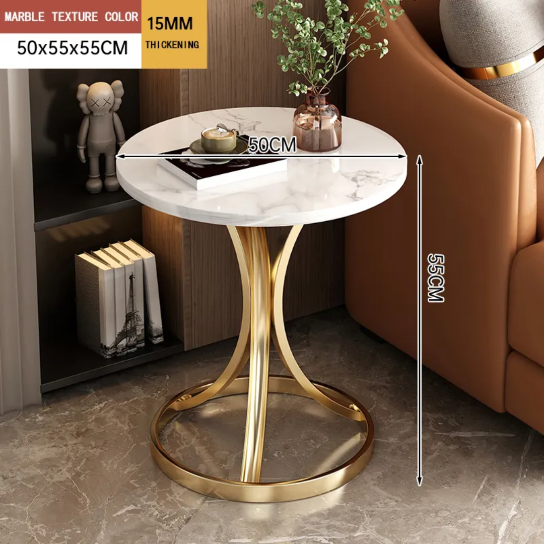 Small round marble table with gold legs in a living room setting
