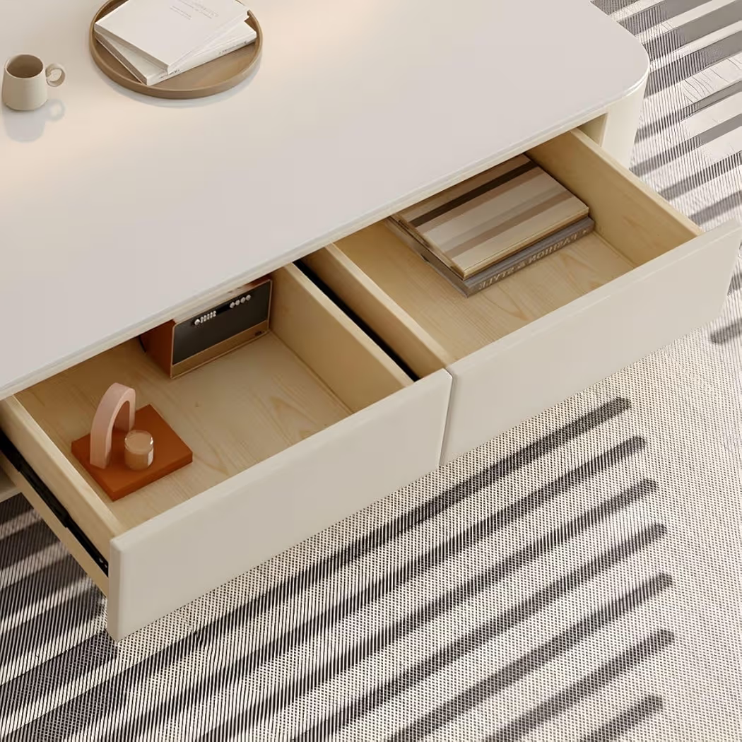 Open drawer with wooden items on a striped rug