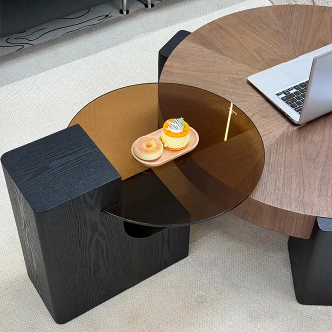 Round glass table with a black base in an office setting